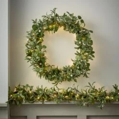 Guirlande De Noël Pré-éclairée En Gui Et Eucalyptus De 2 M 5 Guirlande De Noël Pré-éclairée En Gui Et Eucalyptus De 2 M -Éclairage Domestique D LL WRGA24012 guirlande avec la couronne assortie